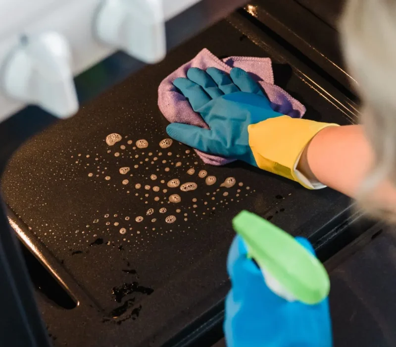 A Woman Cleaning the Oven
