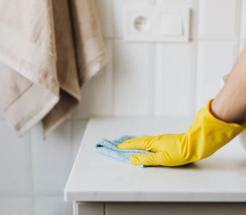 Crop Housemaker Cleaning Surface Near Sink