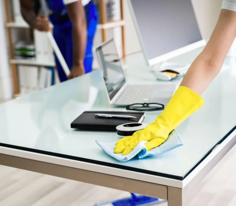 Male And Female Cleaners Cleaning Office
