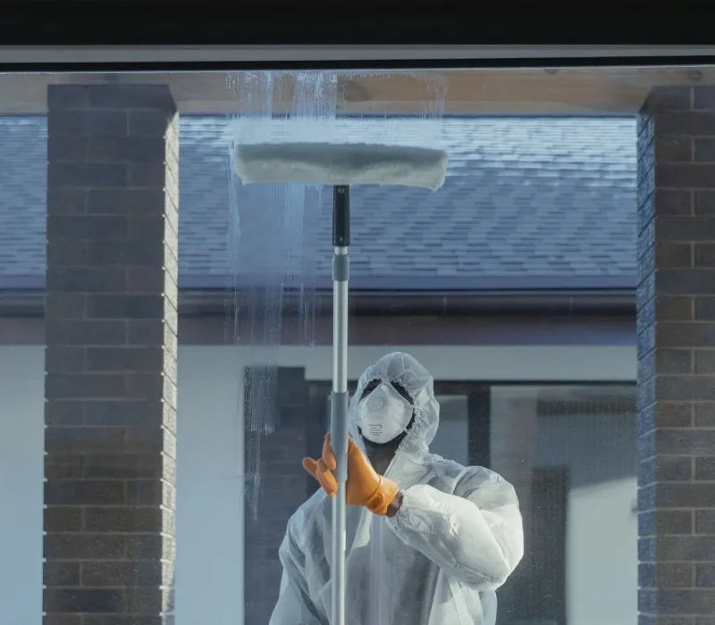 Man Cleaning Glass Window