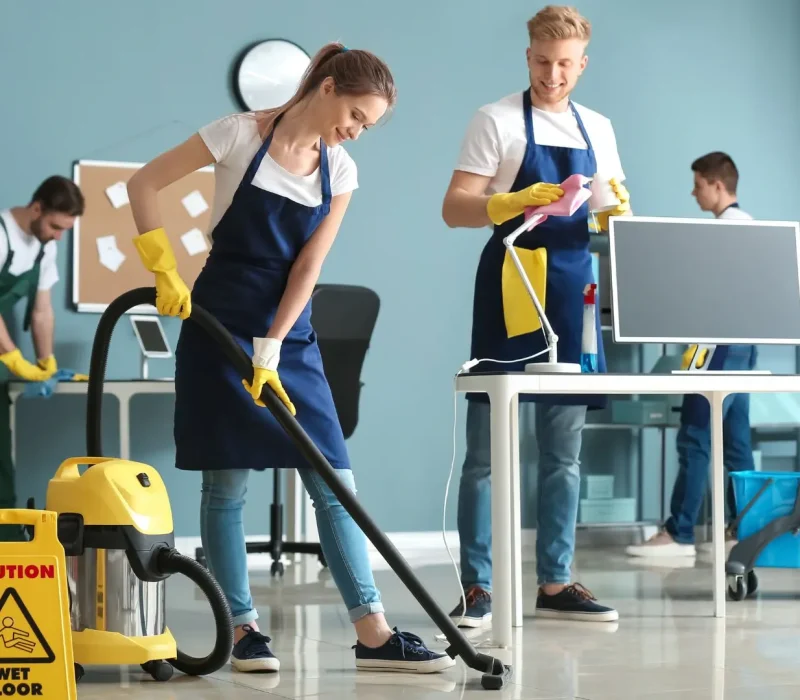 Team of Janitors Cleaning Office Floor